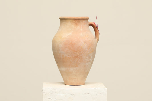 A one-of-a-kind neutral Turkish vintage vase pot with a handle, crafted from terra cotta clay, this piece showcases timeless quality and antique craftsmanship, adding a unique touch of history to your space