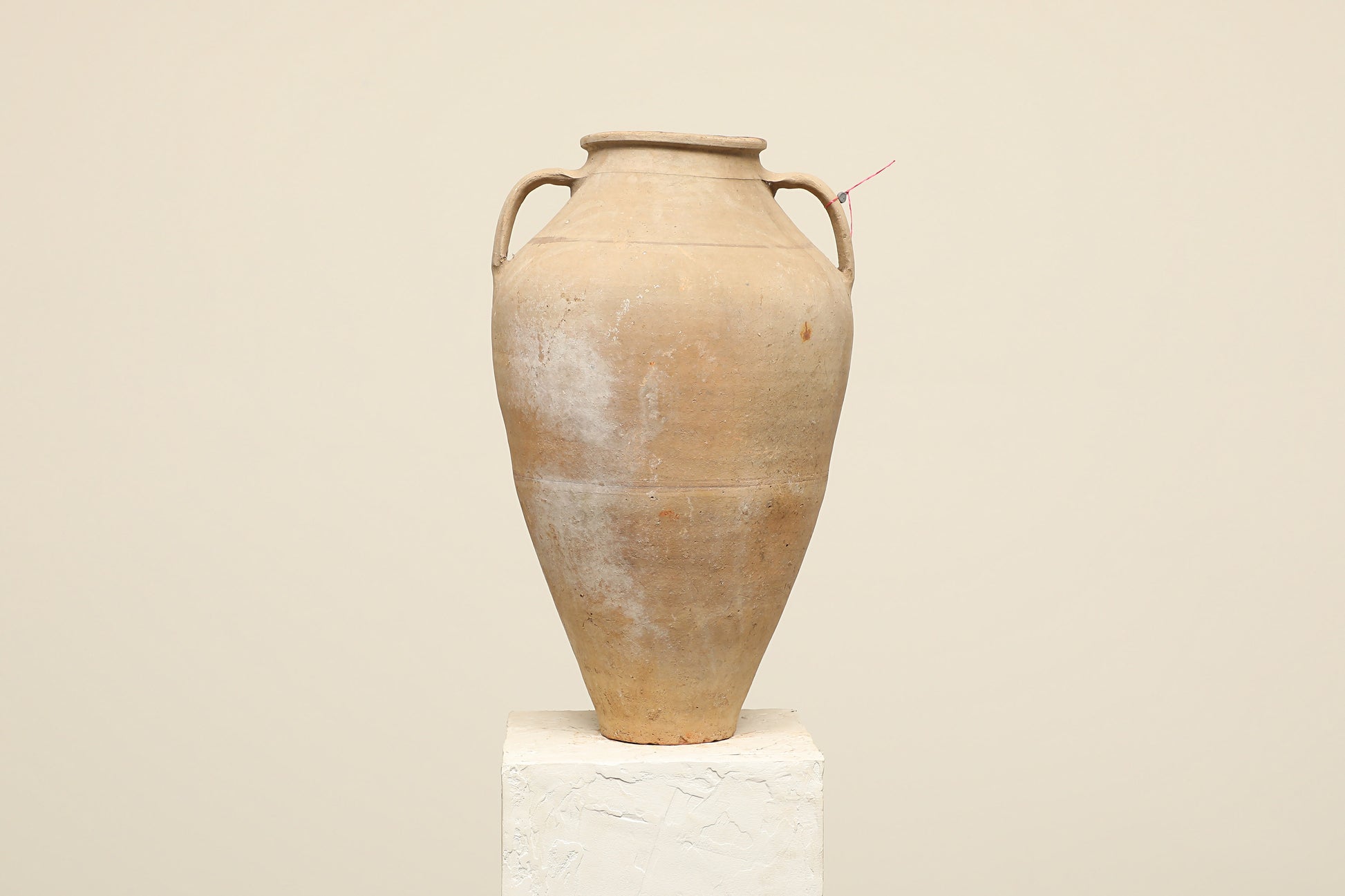 A one-of-a-kind neutral Turkish vintage vase pot with two handles, crafted from terra cotta clay, this piece showcases timeless quality and antique craftsmanship, adding a unique touch of history to your space