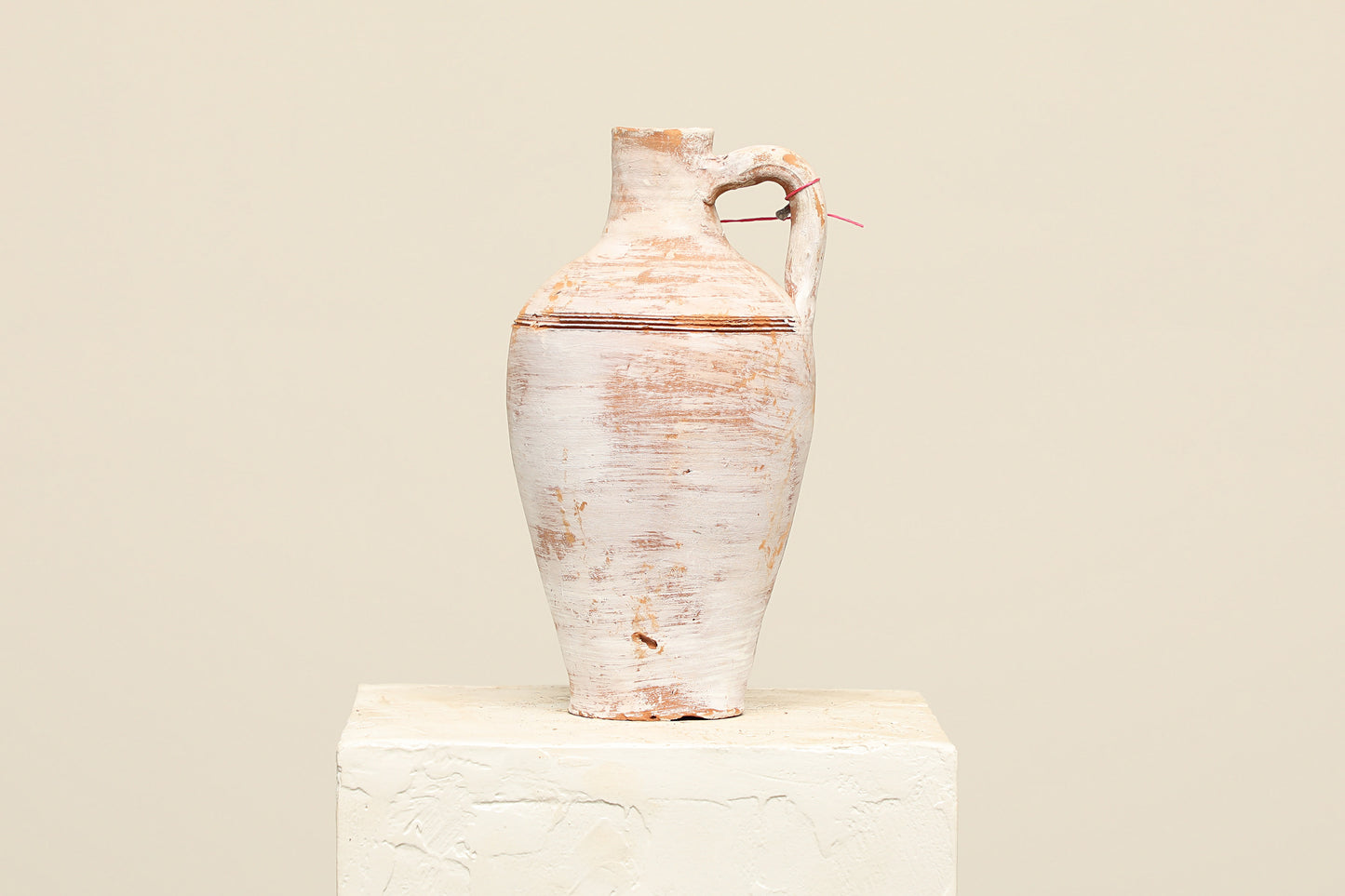 A one-of-a-kind off white Turkish vintage vase pot with a handle, crafted from terra cotta clay, this piece showcases timeless quality and antique craftsmanship, adding a unique touch of history to your space
