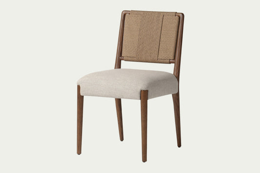 Everyday dining chairs constructed of solid light oak wood, woven back, and thick cushioned seats covered in off-white linen.