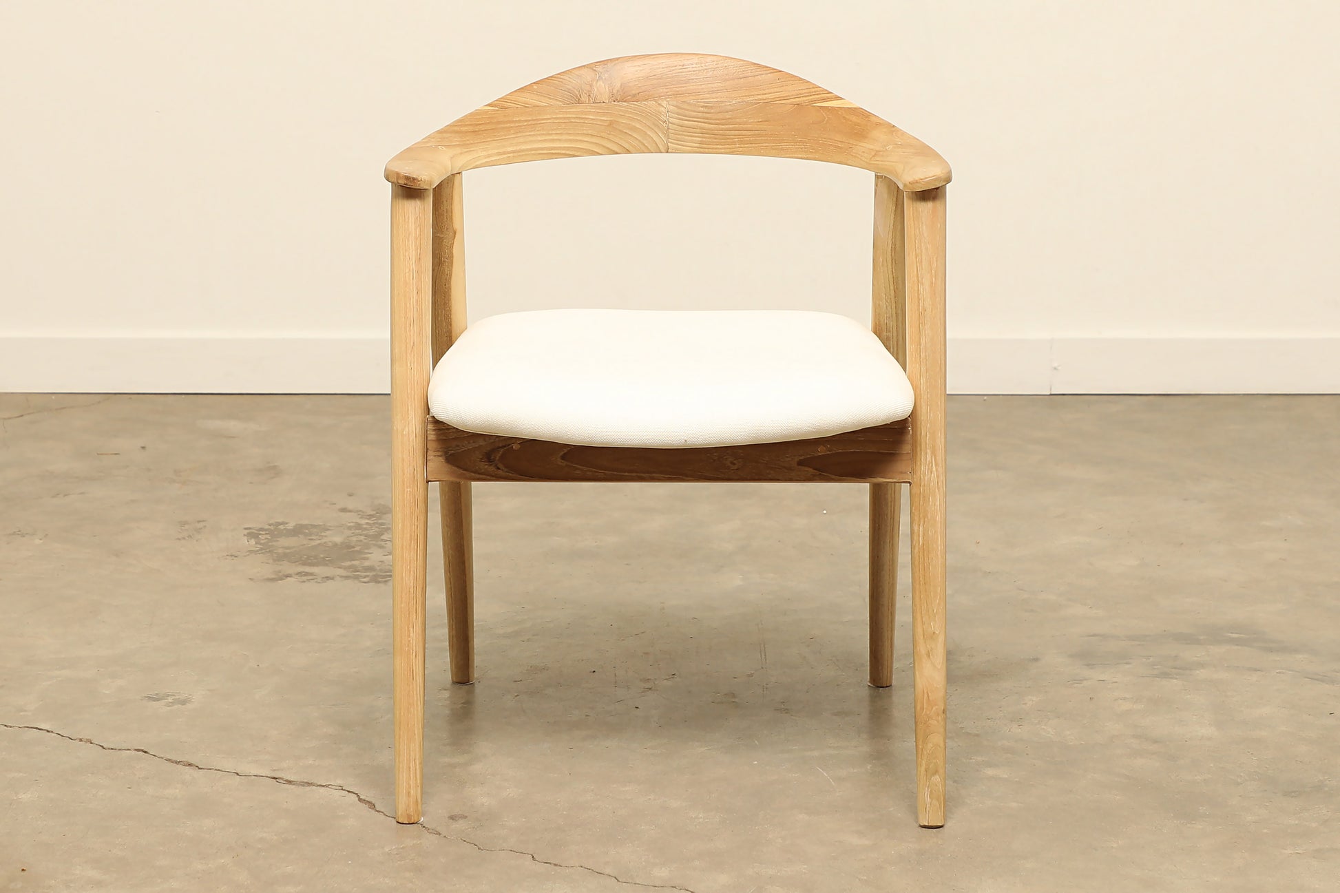 Teak wood Harlow dining chair with a cushioned seat.