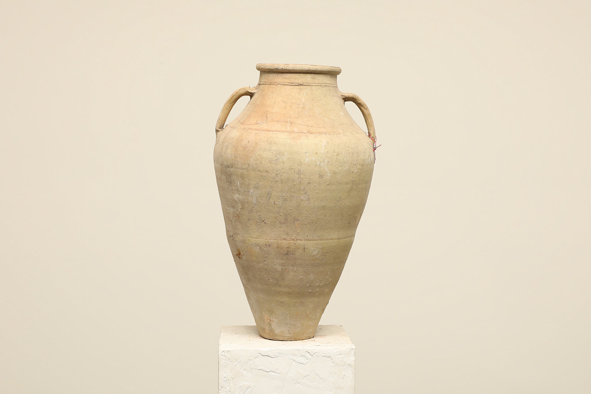 A one-of-a-kind neutral Turkish vintage vase pot with two handles, crafted from terra cotta clay, this piece showcases timeless quality and antique craftsmanship, adding a unique touch of history to your space