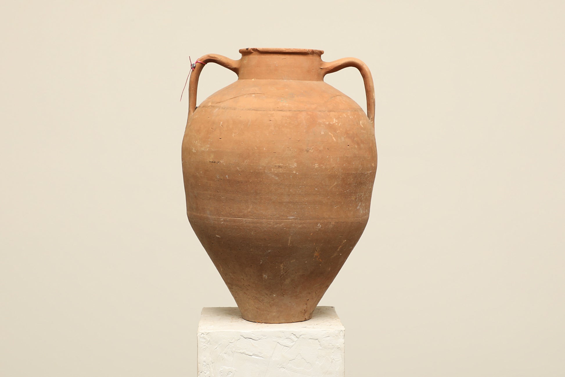 A one-of-a-kind rustic red Turkish vintage vase pot with two handles, crafted from terra cotta clay, this piece showcases timeless quality and antique craftsmanship, adding a unique touch of history to your space