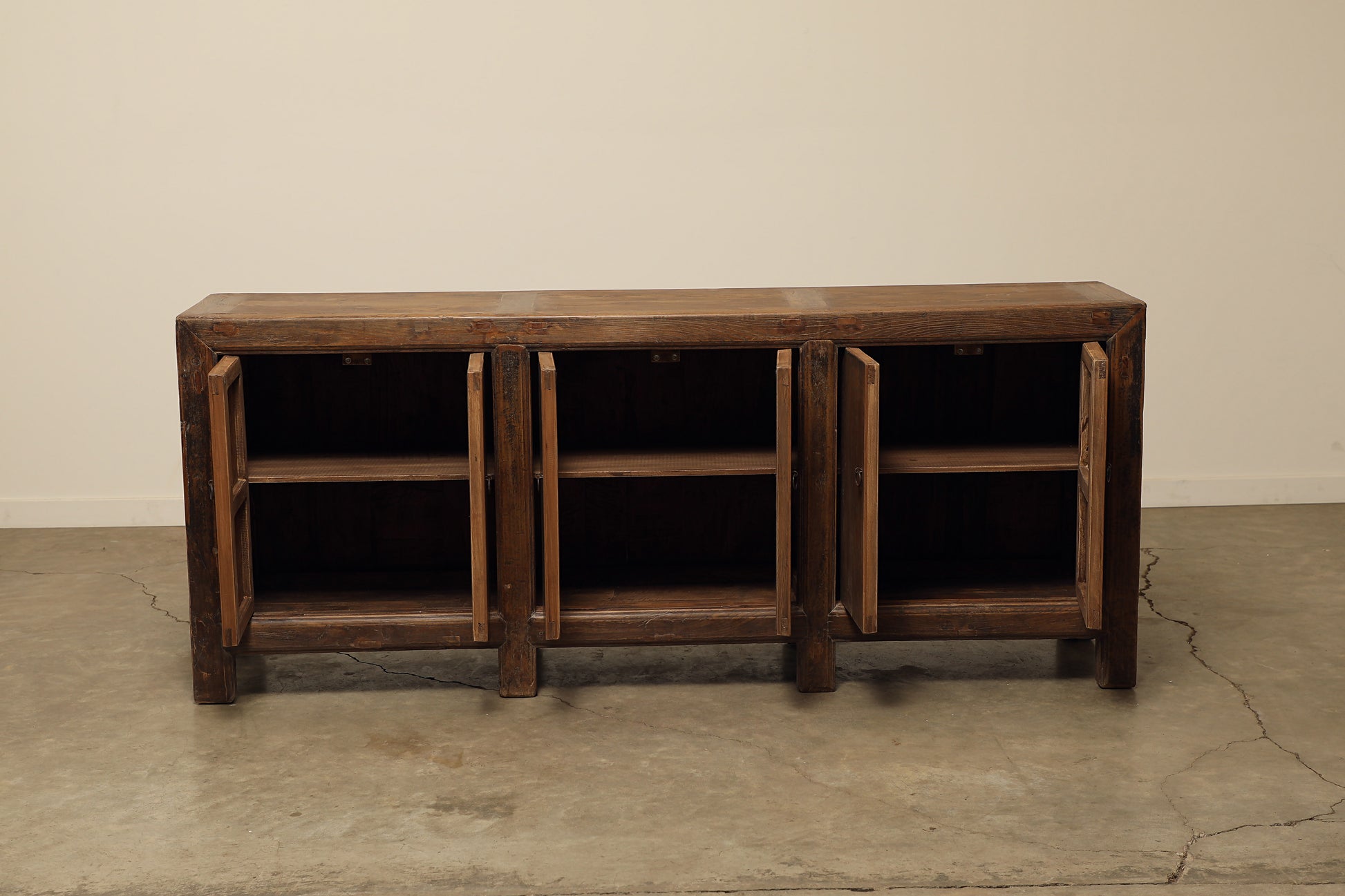 A one-of-a-kind, vintage rustic dark brown sideboard 3 cabinets handcrafted of elm natural wood in a farmhouse style, 85 inches long is narrow at 17 inches.