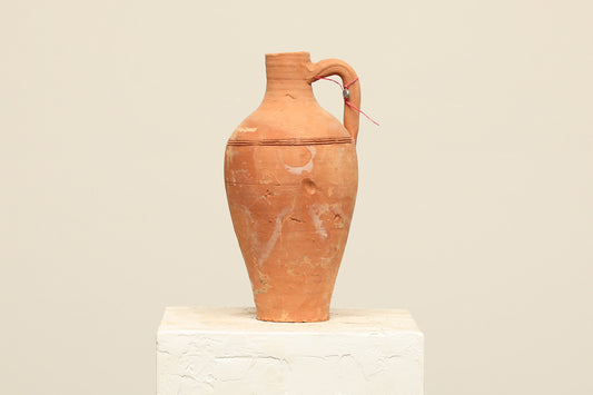 A one-of-a-kind clay brown Turkish vintage vase pot with a handle, crafted from terra cotta clay, this piece showcases timeless quality and antique craftsmanship, adding a unique touch of history to your space