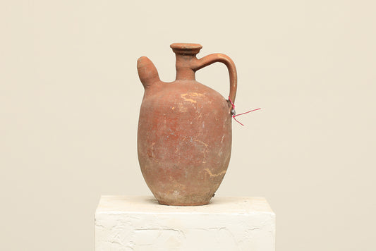 A one-of-a-kind clay brown Turkish vintage vase pot with a handle, crafted from terra cotta clay, this piece showcases timeless quality and antique craftsmanship, adding a unique touch of history to your space