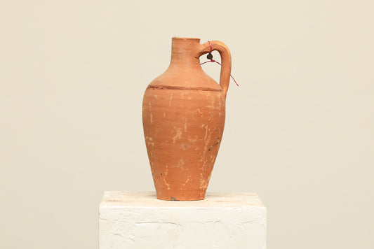 A one-of-a-kind clay brown Turkish vintage vase pot with a handle, crafted from terra cotta clay, this piece showcases timeless quality and antique craftsmanship, adding a unique touch of history to your space