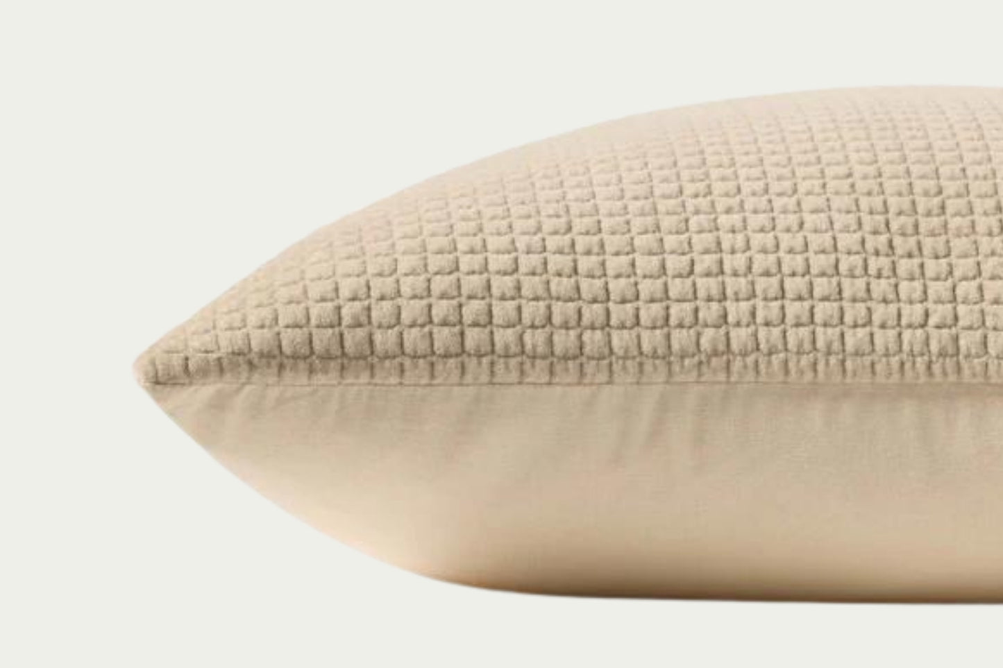 This quilted velvet throw pillow in creamy ivory and beige adds soft texture. Made of 100% cotton, it measures 22-inch square, perfect for styling in living rooms and bedrooms.