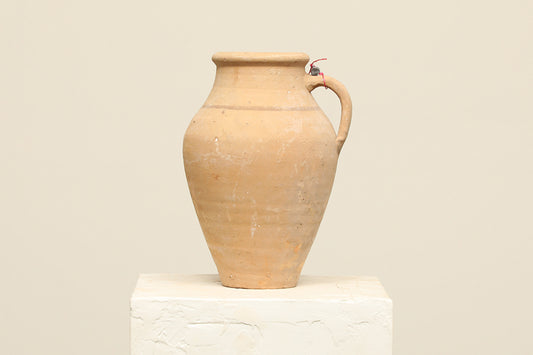 A one-of-a-kind cream Turkish vintage vase pot with a handle, crafted from terra cotta clay, this piece showcases timeless quality and antique craftsmanship, adding a unique touch of history to your space