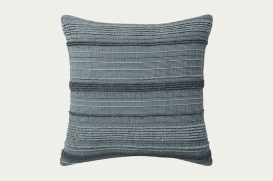 Textured and striped, the Mar modern throw pillow adds dimension and visual interest in varying tones of chambray-like blue. This accent pillow is hand-woven.