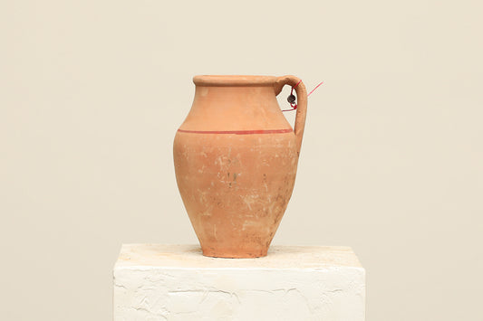 A one-of-a-kind clay brown Turkish vintage vase pot with a handle, crafted from terra cotta clay, this piece showcases timeless quality and antique craftsmanship, adding a unique touch of history to your space