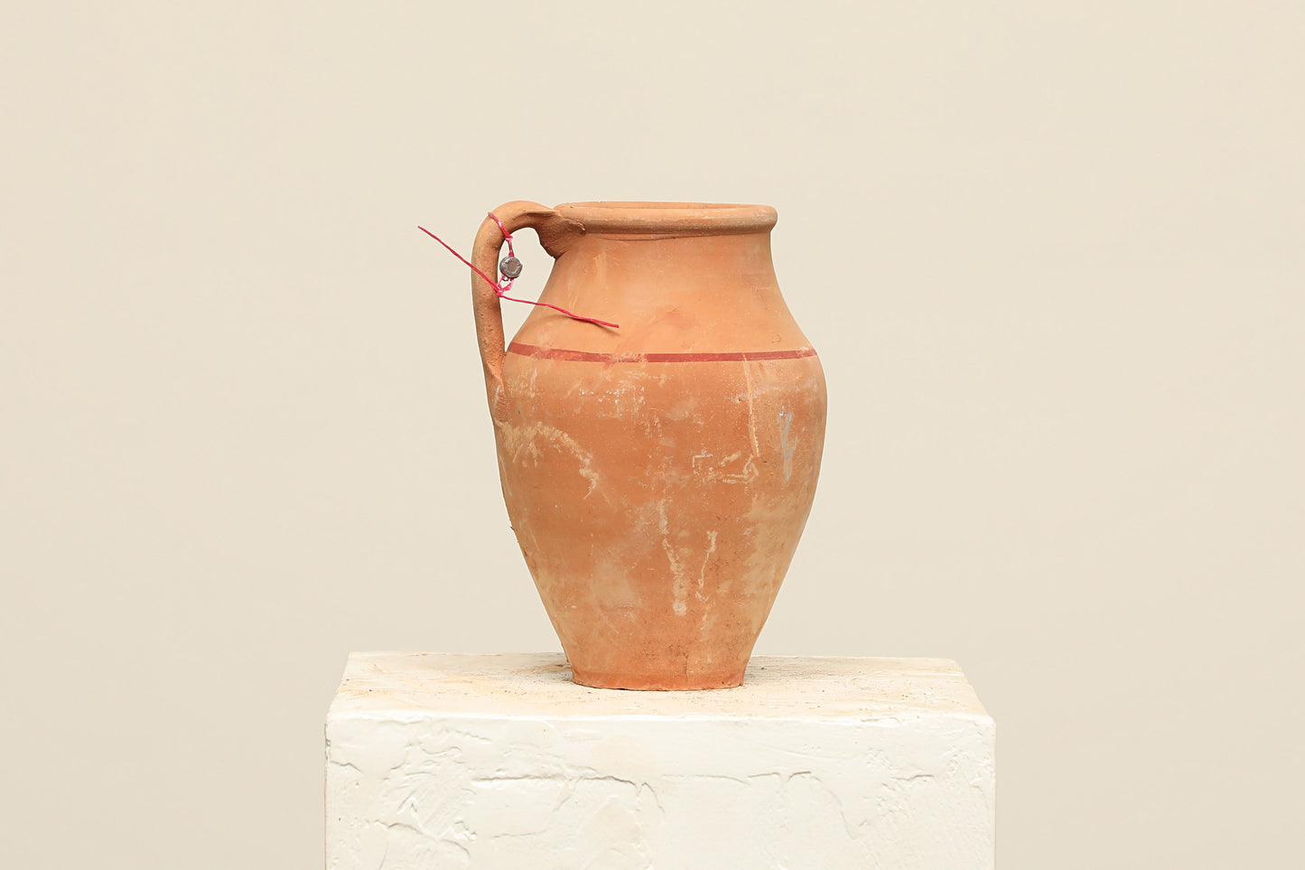 A one-of-a-kind clay brown Turkish vintage vase pot with a handle, crafted from terra cotta clay, this piece showcases timeless quality and antique craftsmanship, adding a unique touch of history to your space