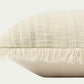Modern throw pillow features a timeless pattern in an ivory and sage palette in a textural boucle with fringe trim on two sides.