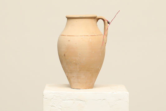 A one-of-a-kind natural Turkish vintage vase pot with a handle, crafted from terra cotta clay, this piece showcases timeless quality and antique craftsmanship, adding a unique touch of history to your space