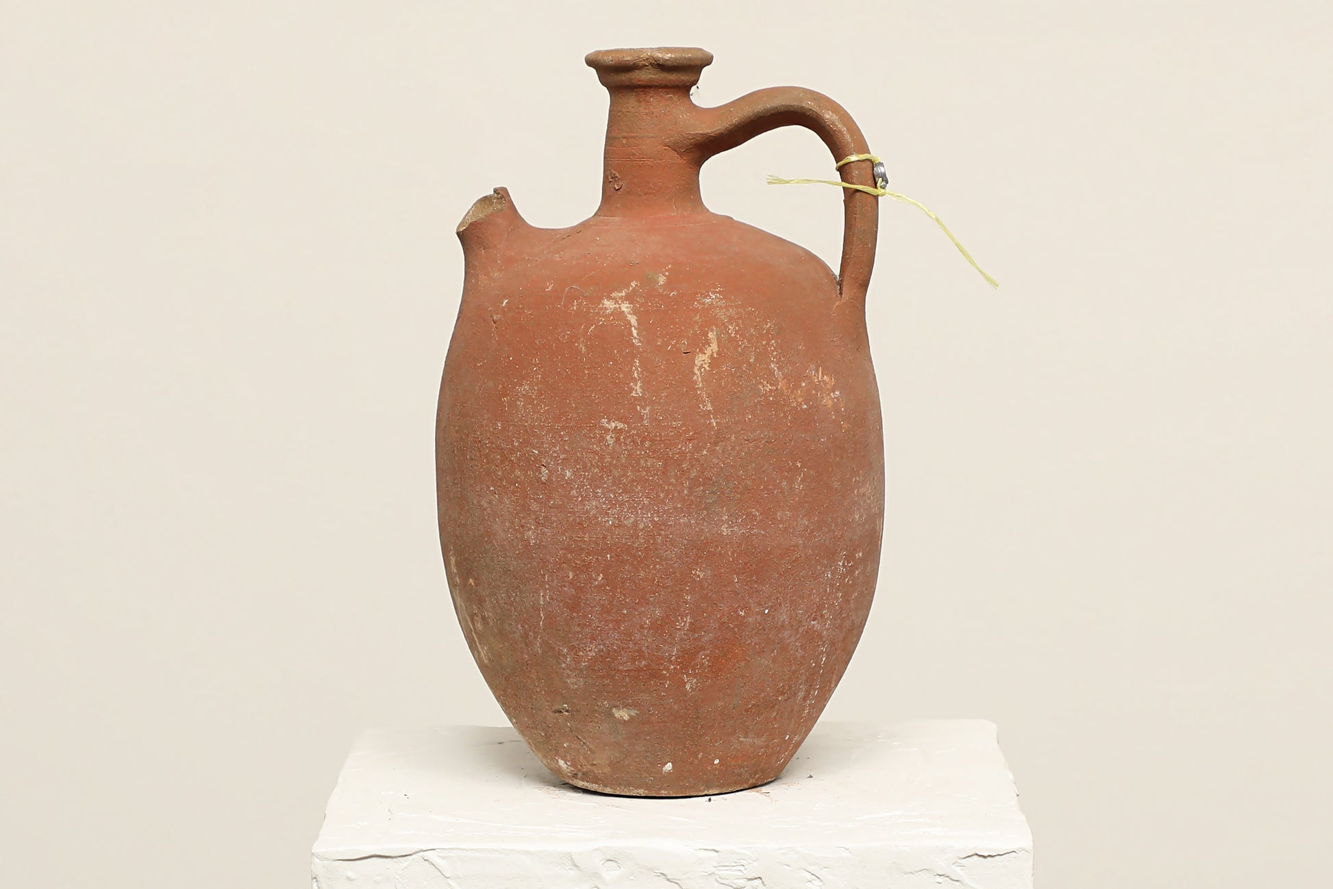A one-of-a-kind clay brown Turkish vintage vase pot with a handle, crafted from terra cotta clay, this piece showcases timeless quality and antique craftsmanship, adding a unique touch of history to your space