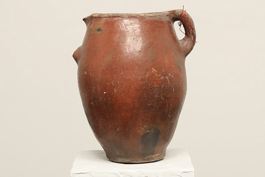 A one-of-a-kind dark brown Turkish vintage vase pot with a handle, crafted from terra cotta clay, this piece showcases timeless quality and antique craftsmanship, adding a unique touch of history to your space