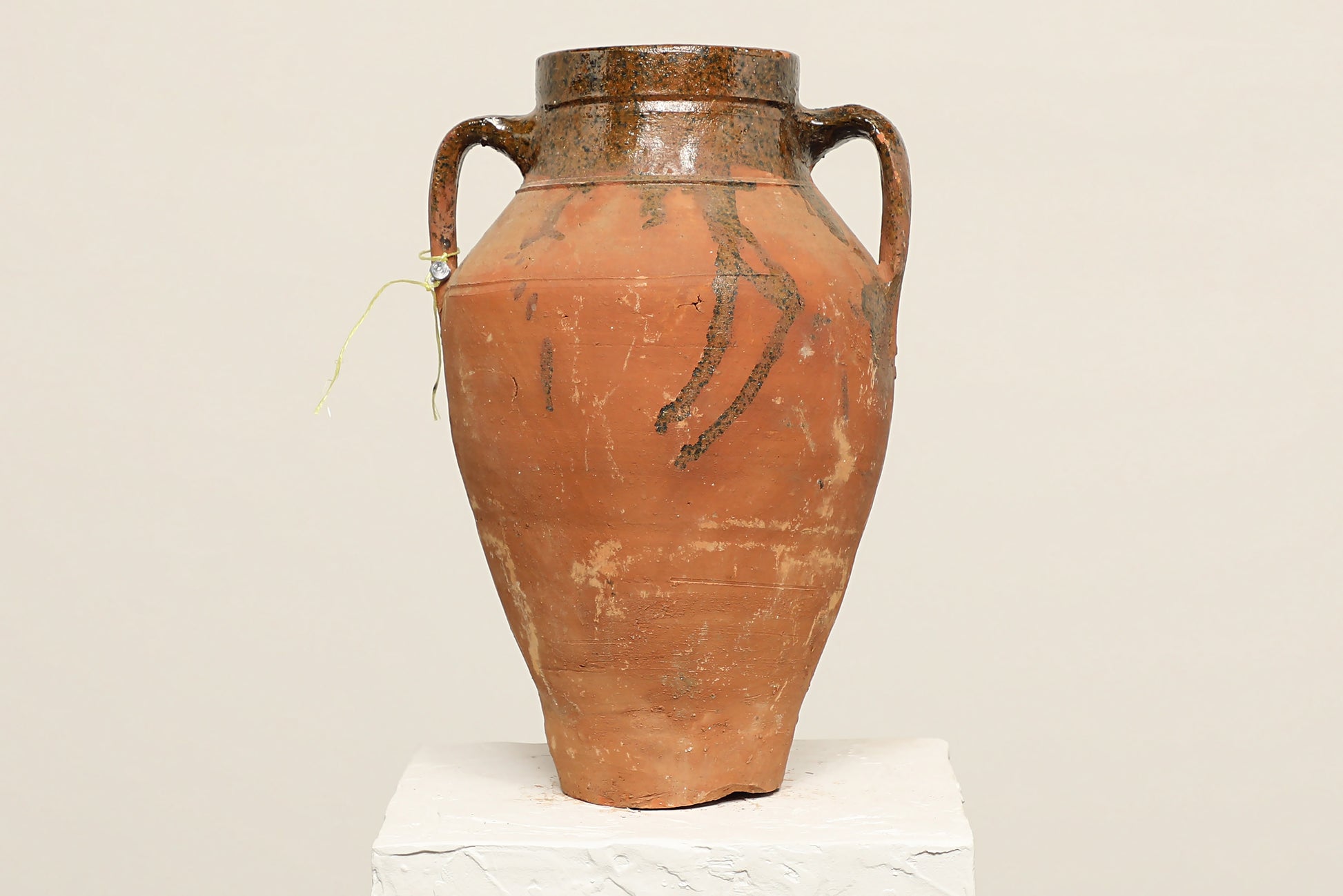 A one-of-a-kind rustic red Turkish vintage vase pot with two handles, crafted from terra cotta clay, this piece showcases timeless quality and antique craftsmanship, adding a unique touch of history to your space