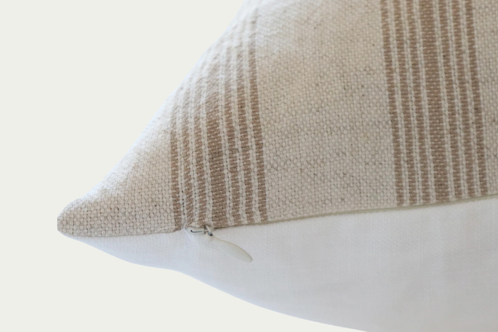 The Lawson Stripe Pillow is ideal for adding neutral texture and dimension to a space. Handwoven, this accent pillow features brown woven stripes on a cream cotton background and a 100% heavy-weight linen back.