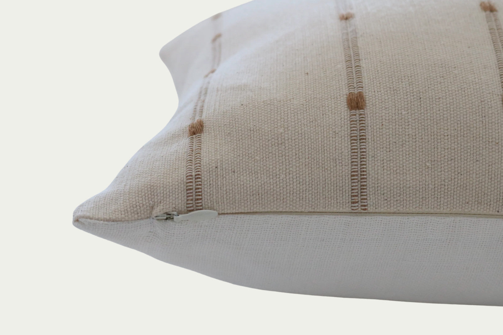 Brown woven stripes on a cream cotton background and a 100% off-white linen back in a 20-inch by 30-inch rectangle.