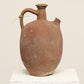 A one-of-a-kind clay brown Turkish vintage piece with a handle, crafted from terra cotta clay, this piece showcases timeless quality and antique craftsmanship, adding a unique touch of history to your space