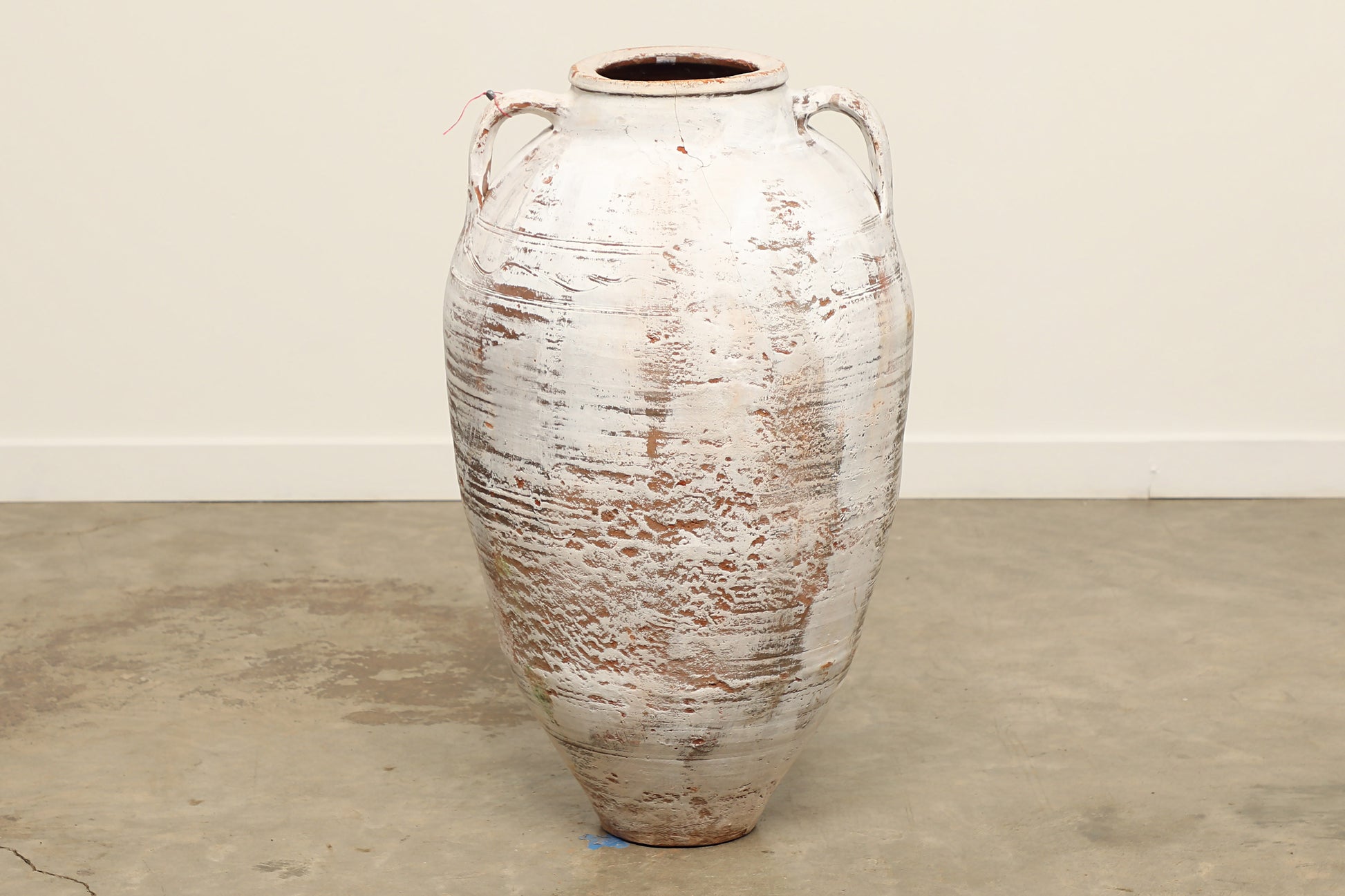 A one-of-a-kind white Turkish vintage vase pot with two handles, crafted from terra cotta clay, this piece showcases timeless quality and antique craftsmanship, adding a unique touch of history to your space